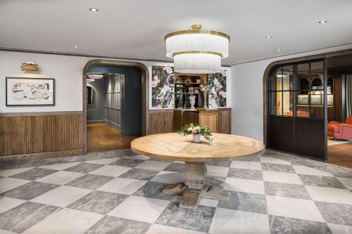 a dining room with a table and a checkered floor at Wylie Hotel Atlanta, Tapestry Collection by Hilton in Atlanta