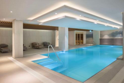 a large pool with blue water in a building at Hampton By Hilton Cerkezkoy in Tekirdag