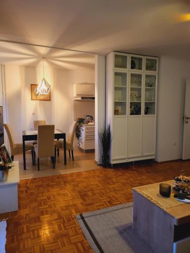 a living room with a table and a dining room at Dolly Apartment Airport in Velika Gorica
