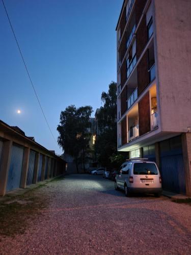 a car parked in a parking lot next to a building at Dolly Apartment Airport in Velika Gorica