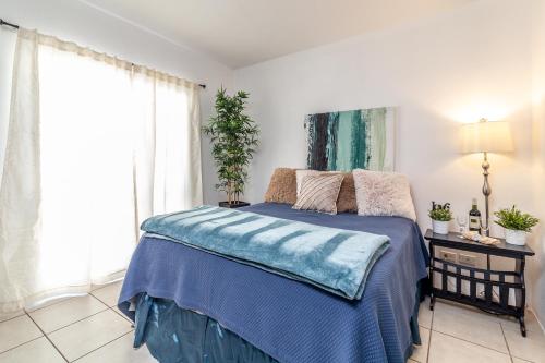 um quarto com uma cama com um cobertor azul em Beach Vibes 72 Gardenhaus em Tijuana