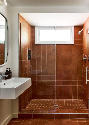 a bathroom with a sink and a shower at Bluebird Cady Hill Lodge in Stowe