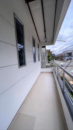 an empty balcony of a white building with windows at HOTEL BOUTIQUE CRISTOFF in Apartadó