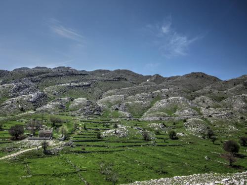 a view of a mountain with a green field at Rodami in Kalentzi
