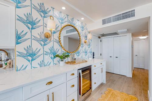 a bathroom with a sink and a mirror at Bird of Paradise in Marco Island