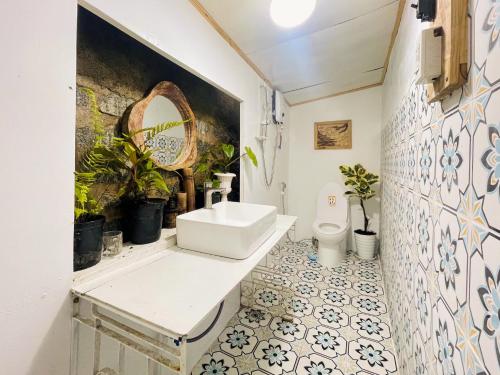 a bathroom with a sink and a toilet at Hat De homestay in Xuan An