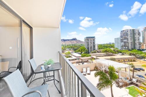 a balcony with a table and chairs and a view of the city at Diamond Head View Close to Waikiki Beach with Parking in Honolulu