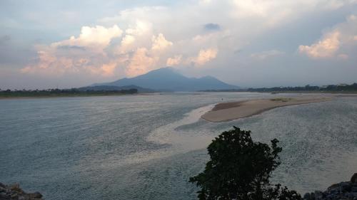 a large body of water with mountains in the background at Wyndham Thanh Thuy Hot Spring MyHome in Phú Thọ