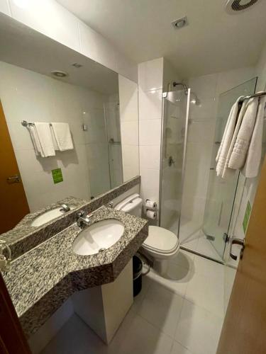 a bathroom with a sink and a shower and a toilet at S4 Hotel Águas claras flat particular fora do pool in Brasilia