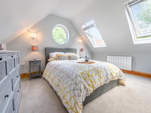 a bedroom with a bed and two windows at The Retreat - Uk45099 in Kirklington