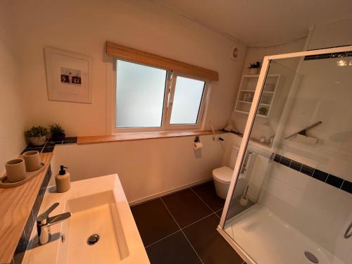 a bathroom with a sink and a shower at Tutukaka Sunrise in Tutukaka