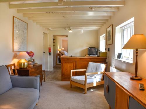 a living room with a couch and a table at Little House On The Common in Wortham