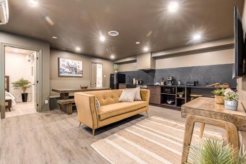 a living room with a couch and a kitchen at North House - St Ursule Two-Storey Oasis in Quebec City
