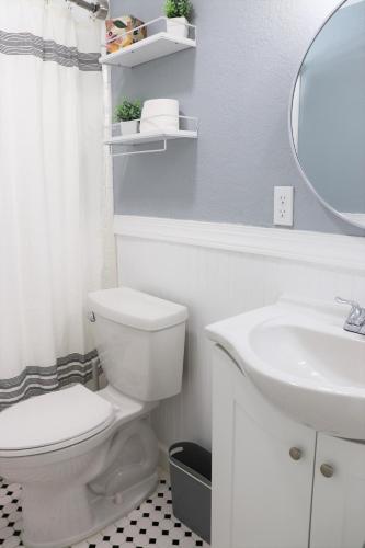 a bathroom with a white toilet and a sink at Luxury Studio Suite close to Tampa Airport in Tampa