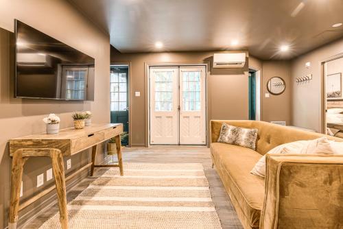 a living room with a couch and a table at North House - St Ursule Two-Storey Oasis in Quebec City