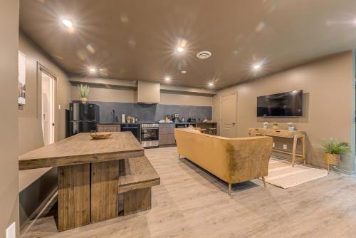 a large kitchen with a table and a couch at North House - St Ursule Two-Storey Oasis in Quebec City