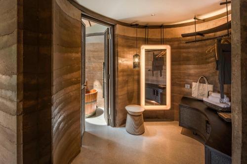 a bathroom with wooden walls and a sink and a tub at Patamma Hideaway Resort in Nan