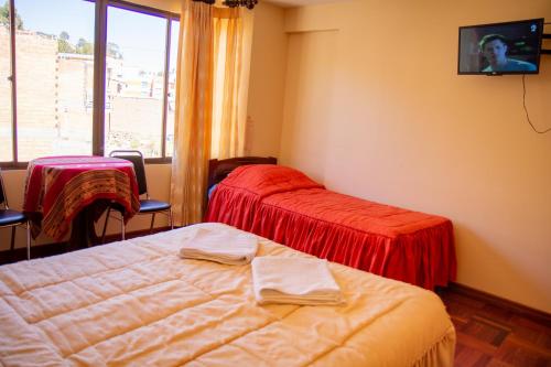 a hotel room with two beds and a window at Hostal Sonia in Copacabana