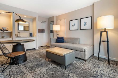 a living room with a couch and a table at Sheraton Suites Old Town Alexandria in Alexandria