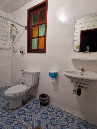 a bathroom with a toilet and a sink at Romantic Time Mountain Resort in Pai