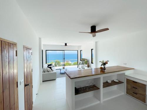 a living room with a table and a ceiling fan at Infinity Villa in Salad Beach