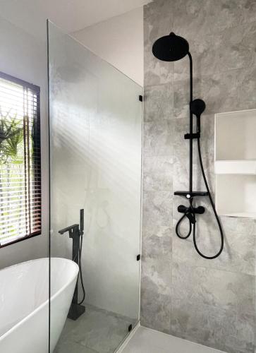 a bathroom with a shower and a bath tub and a bath tub at Infinity Villa in Salad Beach