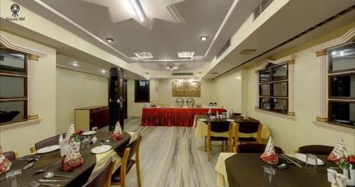 a restaurant with tables and chairs in a room at KANCHAN DEEP in Jaipur