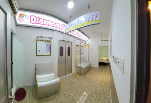 a bathroom with a toilet and a sign on the wall at Language Exchange Hotel 3 in Ho Chi Minh City