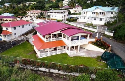 an aerial view of a house with pink roofs at Chalet Belizomi Tropical Villas Studio Villa #3 in Gros Islet