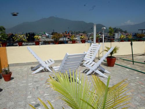 two white chairs sitting on top of a roof at Elbrus Home in Kathmandu