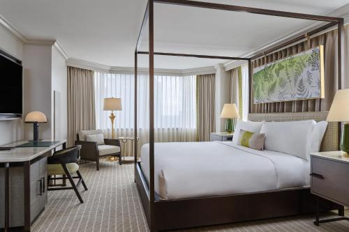a hotel room with a large bed and a desk at The Whitley, a Luxury Collection Hotel, Atlanta Buckhead in Atlanta