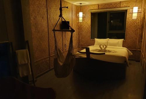 a room with a bed with a hammock in it at Language Exchange Hotel 3 in Ho Chi Minh City