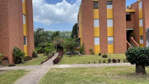 a large brick building with a garden in front of it at Golden Meadows Oasis in Golden Spring