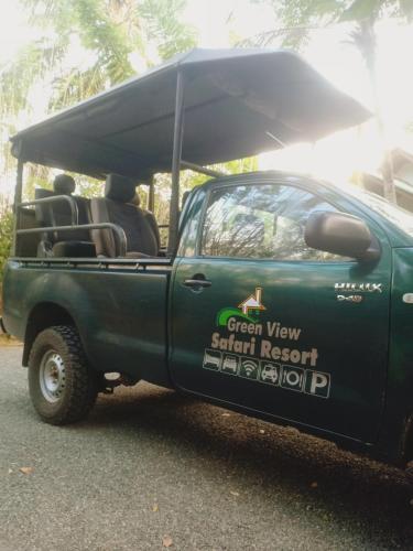 a green truck with a canopy on the back at Green View Safari Resort in Udawalawe