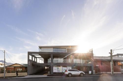 a building with a car parked in front of it at Little Island Apartments in Hobart