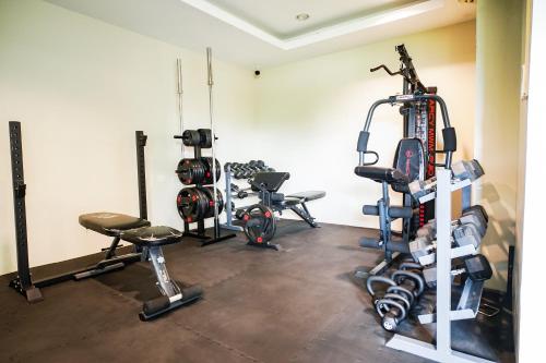 a gym with several tread machines in a room at Modern Designed Studio Condo Near Ayala Centrio in Cagayan de Oro