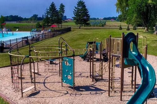 a playground with a slide in a park at Resort near wineries, river, trails! Large Pool! in Niagara-on-the-Lake