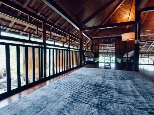 a large room with a large rug on the floor at Thavill Retreat HaGiang in Ha Giang