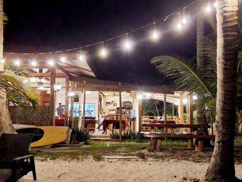 a building with lights and a table and a surfboard at Charisma Beach Resort in Siquijor