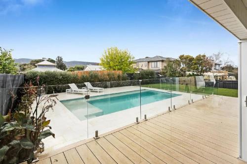 a swimming pool with a fence around it on a wooden deck at The Family Beachside Escape by Ready Set Stay - HOUSE & GUEST HOUSE in Rosebud