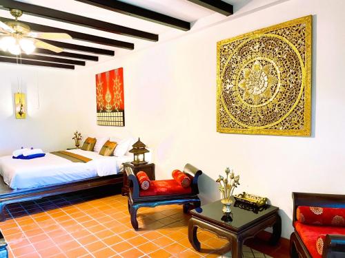 a bedroom with a king sized bed and a couch at Boomerang Village Resort Kata in Kata Beach