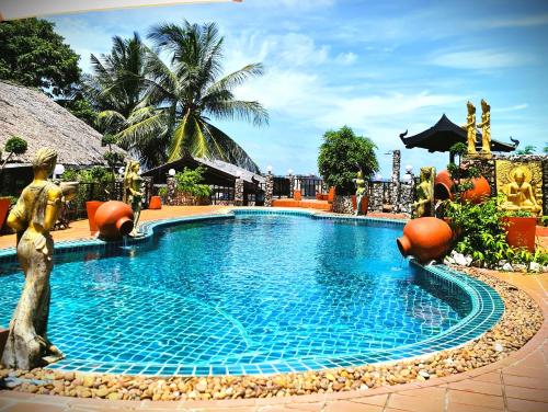 a swimming pool at a resort with a fountain at Boomerang Village Resort Kata in Kata Beach