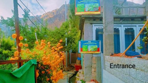a building with a sign that reads entrance at Summer and winter homestay Turtuk Youl in Turtok
