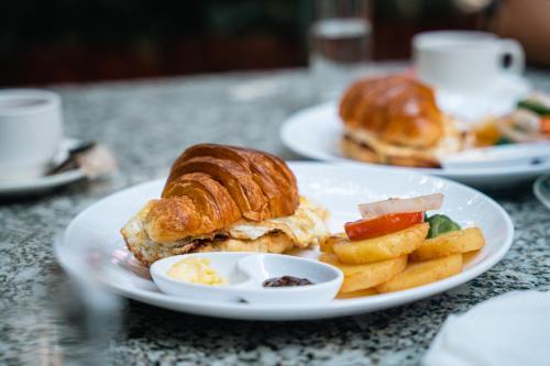 a plate of food with a sandwich and french fries at Kwabahal Boutique Hostel in Kathmandu