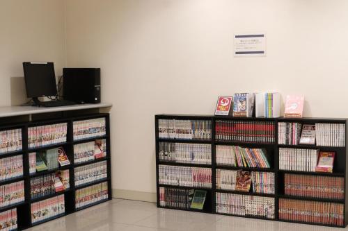 two book shelves filled with dvds at Castle Inn Toyokawa in Toyokawa