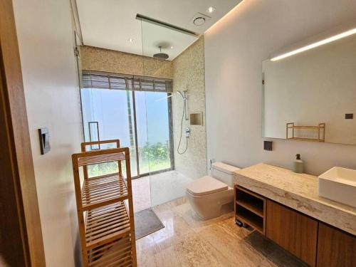 a bathroom with a toilet and a sink and a mirror at Private pool villa 3 Bed, 3 Bath near airport in Phuket