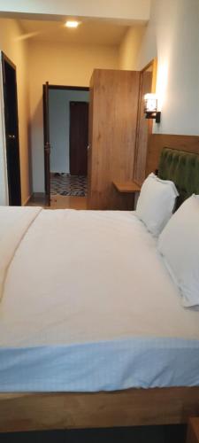 a bedroom with a large white bed in a room at Eve Resort in Patnem