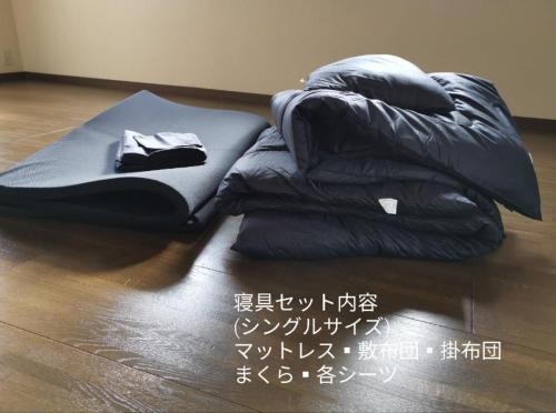 a black sleeping bag on the floor with a sign at Ahouse - Vacation STAY 17245v in Takashima
