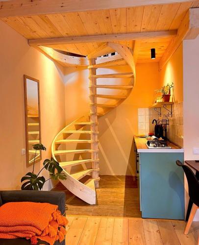 a kitchen with a wooden spiral staircase in a room at Hotel Borjomi Verde in Borjomi