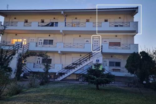 a building with a staircase in front of it at Kofinaki apartment 2 in Tycherón